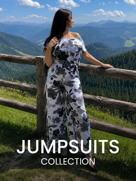 Woman wearing a floral off-shoulder jumpsuit at a mountain viewpoint beside a rustic wooden fence – Cory Edge Women's Jumpsuits Collection