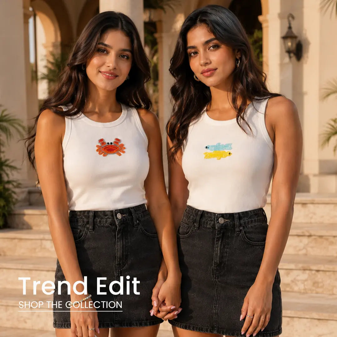 Two women wearing trendy embroidered rib tank tops with black denim skirts in a luxury outdoor setting – Cory Edge Trend Edit Collection