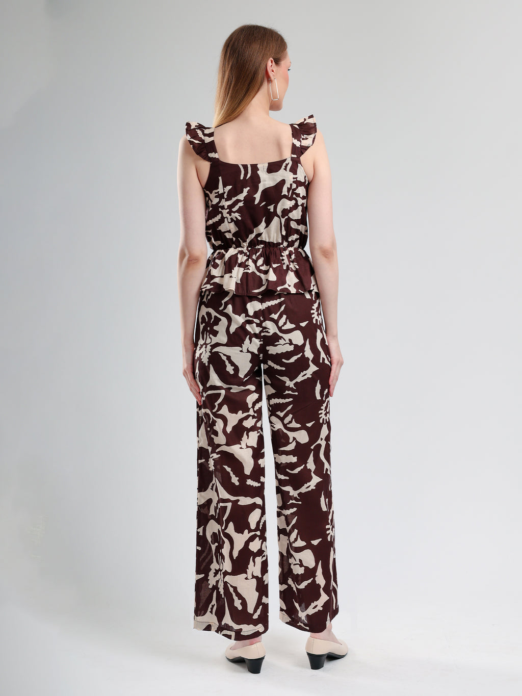 cory edge Woman wearing a patterned jumpsuit 