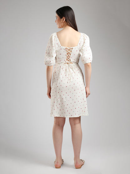 Woman wearing a white floral dress back pose